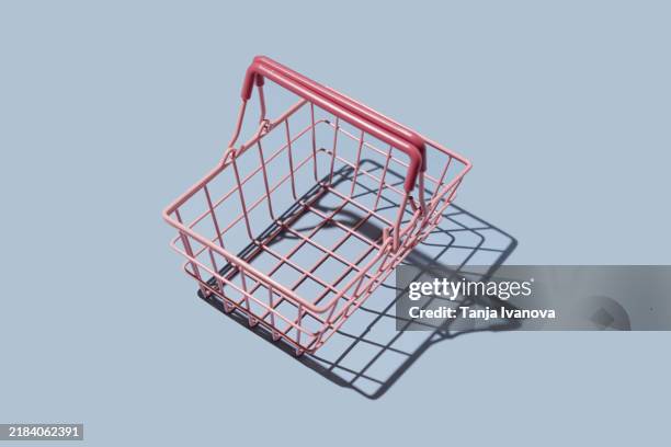 empty shopping basket on blue background. shopping and sale concept. - einkaufskorb stock-fotos und bilder
