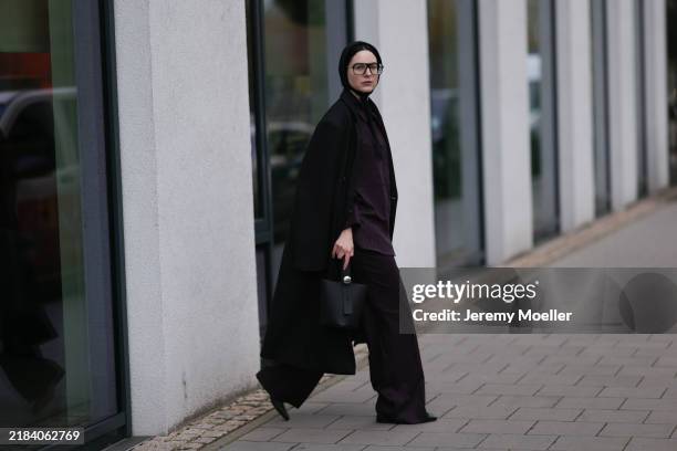 Maria Barteczko is seen wearing oversized square-shaped aviator glasses with a black frame and narrow silver temples from Victoria Beckham; a black...