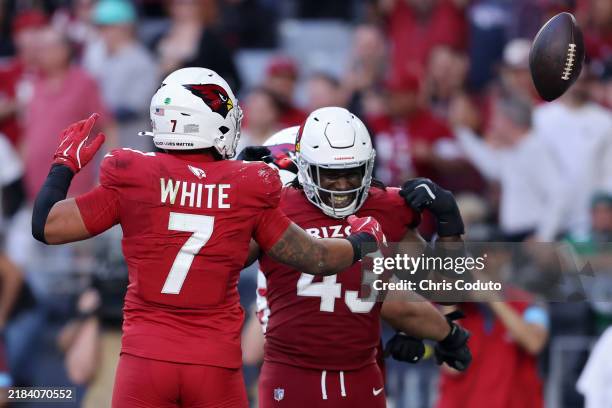 Kyzir White and Jesse Luketa of the Arizona Cardinals celebrate after White recovered a fumble in the third quarter against the New York Jets at...