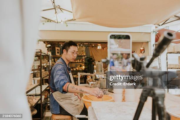 online marketing workshop, asian potter is creating a live streaming via mobile phone. - social media followers stock pictures, royalty-free photos & images