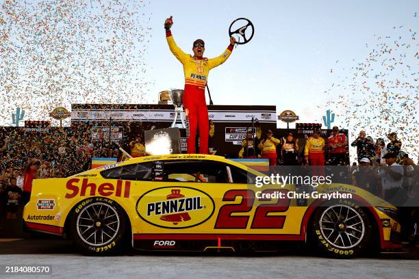 Joey Logano, driver of the Shell Pennzoil Ford, celebrates in victory lane after winning the NASCAR Cup Series Championship Race at Phoenix Raceway...