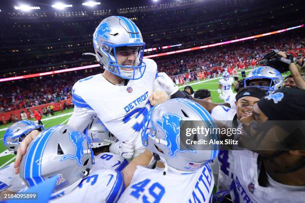 Jake Bates of the Detroit Lions celebrates with teammates after kicking the winning field goal during the fourth quarter against the Houston Texans...