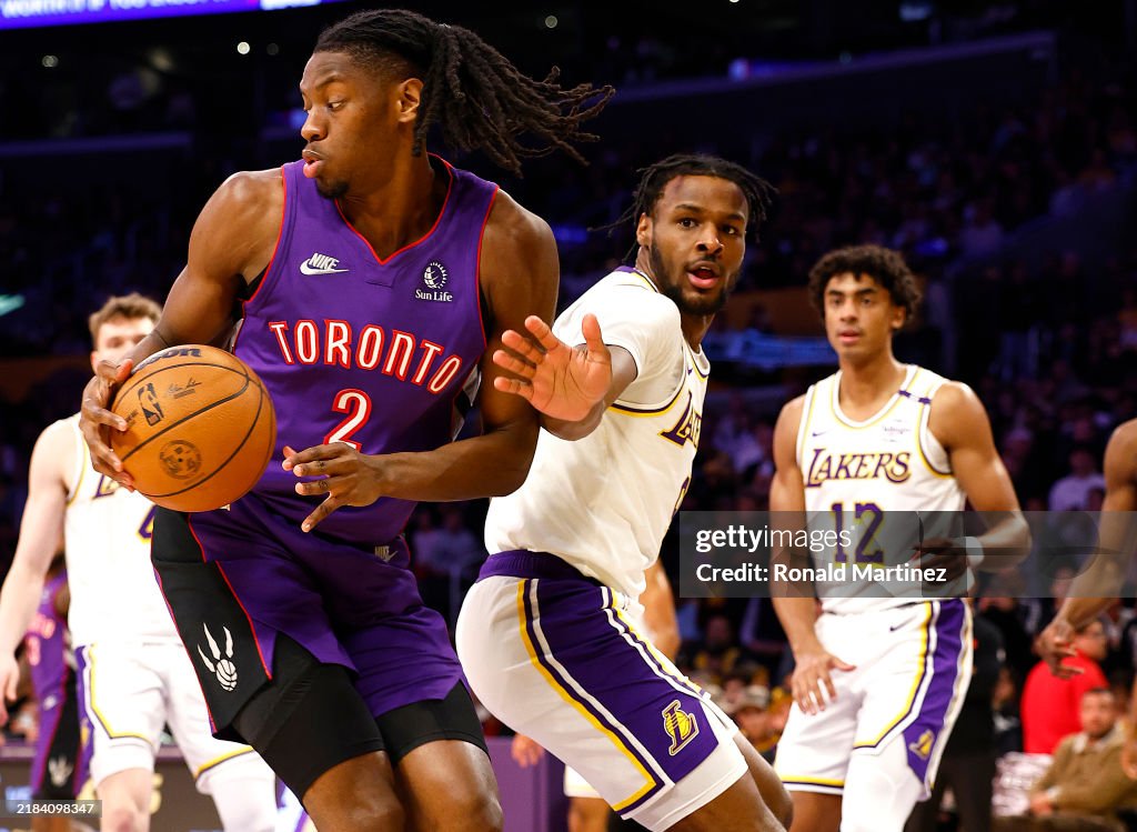 Jonathan Mogbo of the Toronto Raptors controls the ball against... News ...