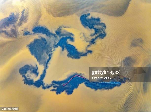Aerial view of a fisherman harvesting saltwater brine shrimps in a salt lake on November 10, 2024 in Yuncheng, Shanxi Province of China.
