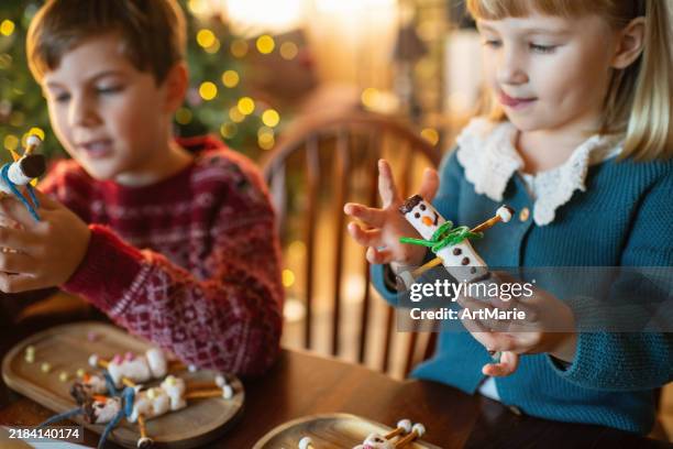 children making marshmallow snowmen in christmas - snowman building stock pictures, royalty-free photos & images