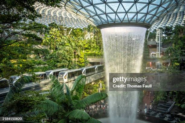 the changi airport skytrain through the jewel in singapore - changi airport stock pictures, royalty-free photos & images