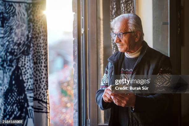 retired old man uses mobile banking, portrait of a man with glasses and white hair - old white man stock pictures, royalty-free photos & images