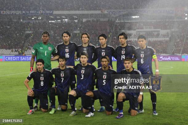 Japan's players pose for a group photo prior to the start of the 2026 World Cup Asian Group C qualification football match between Indonesia and...