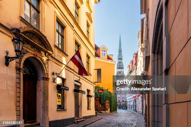 cobbled streets of riga old town and st. peter's church on a sunny day, riga, latvia - capital of latvia stock pictures, royalty-free photos & images