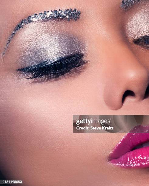 close-up of a woman with dramatic silver eye makeup and pink lipstick showcasing a bold beauty look - silver lipstick stock pictures, royalty-free photos & images