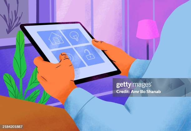 close-up of hands using a tablet with smart home control interface against a cozy indoor background - cozy background stock illustrations