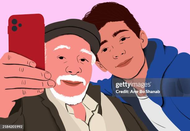 bildbanksillustrationer, clip art samt tecknat material och ikoner med elderly man with white beard and flat cap takes a selfie with a smiling young man in a blue hoodie using a red smartphone - ung vuxen
