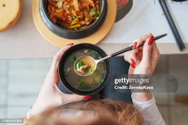 dining table with a soup bowl and korean food bibimbap from above. - soup stock pictures, royalty-free photos & images