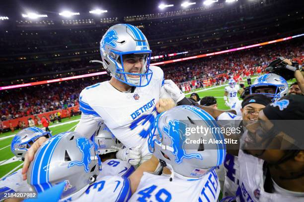 Jake Bates of the Detroit Lions celebrates with teammates after kicking the winning field goal during the fourth quarter against the Houston Texans...