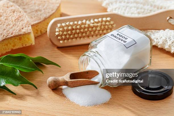 baking soda in a glass jar, scrubbing brush and cleaning sponge. zero waste eco friendly cleaning concept - alkaline food stock pictures, royalty-free photos & images