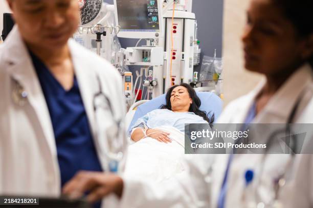 female patient sleeps in emergency department - triage stock pictures, royalty-free photos & images