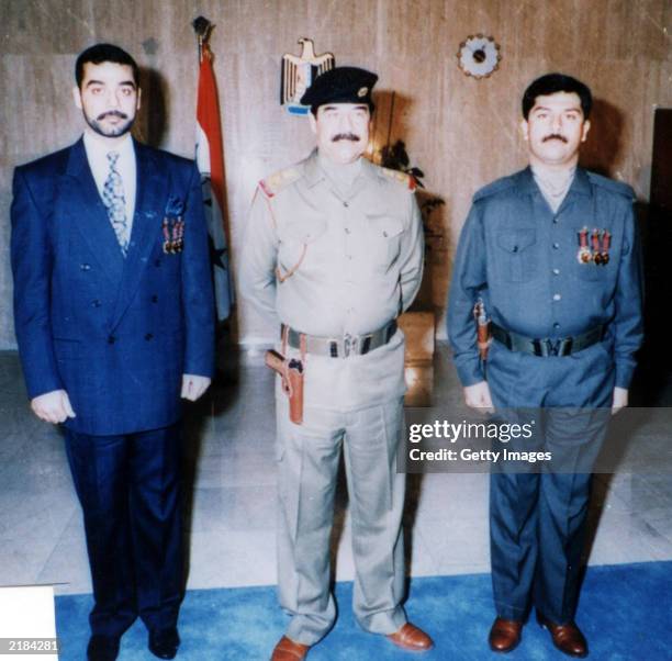 In this undated photo, Saddam Hussein poses with his sons Uday and Qusay . Unconfirmed reports indicate that Saddam Hussein's sons Uday and Qusay may...