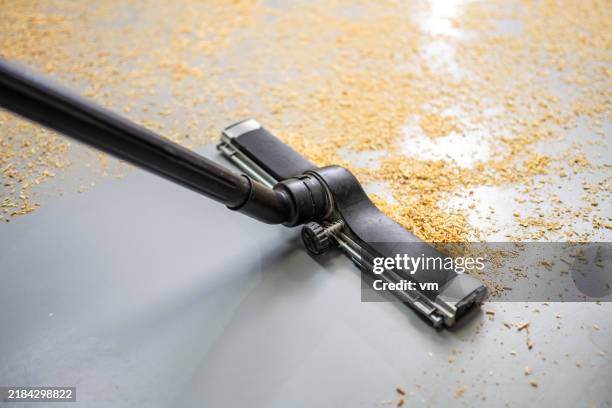 vacuum cleaner in action at workshop - cleaning sawdust stock pictures, royalty-free photos & images