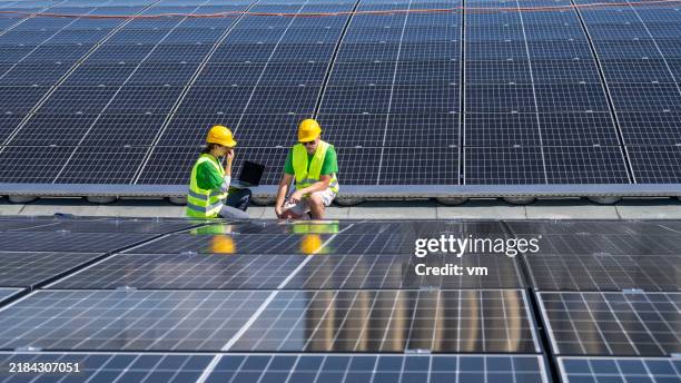 professional technicians installing solar panels - make better stock pictures, royalty-free photos & images