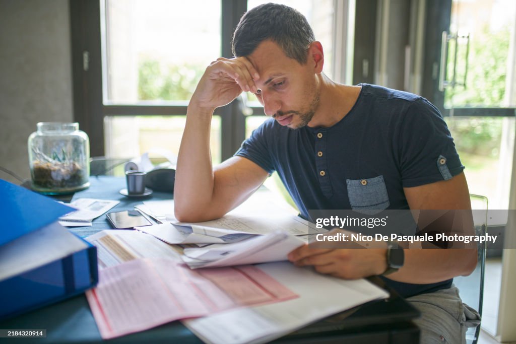 Man preparing his taxes at home