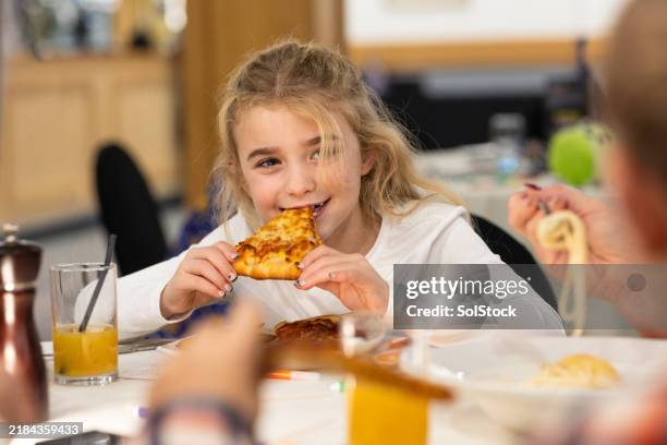 enjoying a tasty pizza slice - pizza restaurant stock pictures, royalty-free photos & images