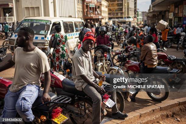 'Boda boda' - motorcycle taxis - drivers wait for customers in Kampala on November 15, 2024. 'Boda boda' - a term with an uncertain origin that...