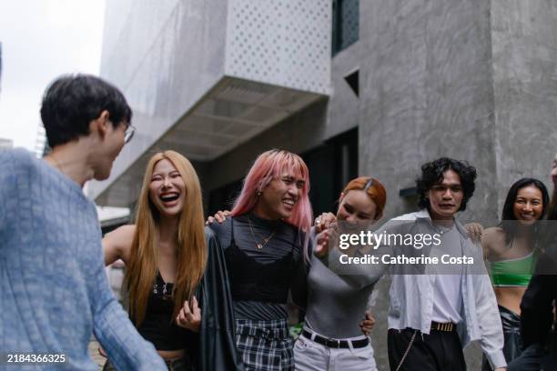 group of cheerful queer friends at an event - stock photo - fashion industry stock pictures, royalty-free photos & images