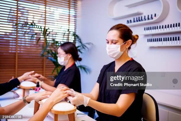 women having manicure at beauty spa - pedicure nail art stock pictures, royalty-free photos & images
