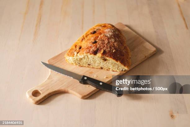 rustic oil bread on a table seen from above - bread knife stock pictures, royalty-free photos & images