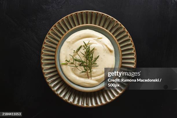 a photo of a sauce plate with homemade mayonnaise - mayonaise stockfoto's en -beelden