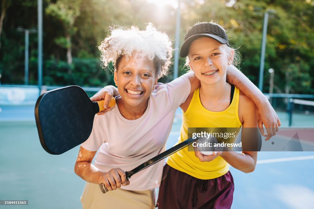 Portrait of friendly children playing pickleball