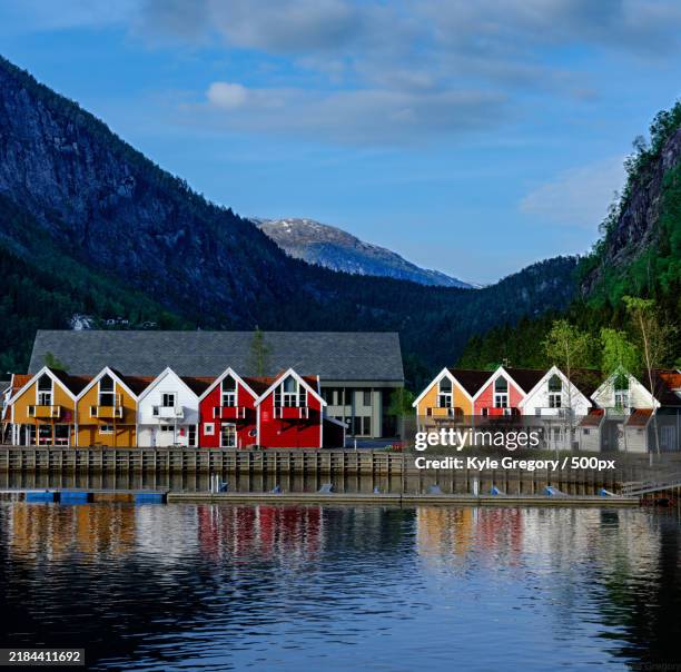 scenic view of lake by buildings against sky,bergen,vestland,norway - bergen foto e immagini stock