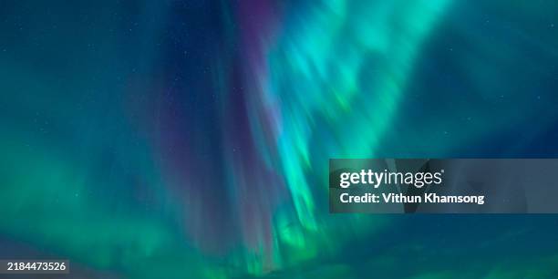 strong kp index aurora borealis (northern lights) exploding over on sky at norway - aurora stock pictures, royalty-free photos & images