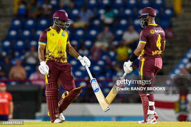 Evin Lewis and Shai Hope of West Indies celebrate their 100 runs partnership during the 4th T20I cricket match between England and West Indies and at...