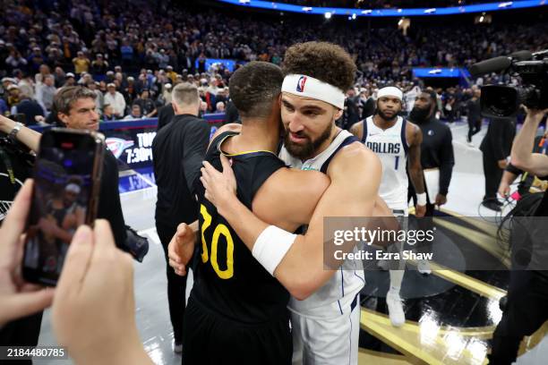 Klay Thompson of the Dallas Mavericks hugs former teammate Stephen Curry of the Golden State Warriors after their game at Chase Center on November...