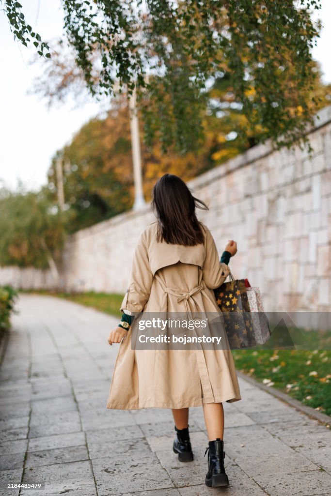 Happy woman enjoying walk on city quay after shopping
