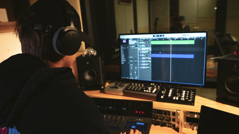 https://media.gettyimages.com/id/2184491195/video/a-young-male-producer-in-a-hoodie-is-using-equipment-in-a-recording-studio-to-compose-and.jpg?b=1&s=640x640&k=20&c=zuFs78vW-vxWV1wT_WRhNb2HJmr4JTh8UbuNP9gOMh8=