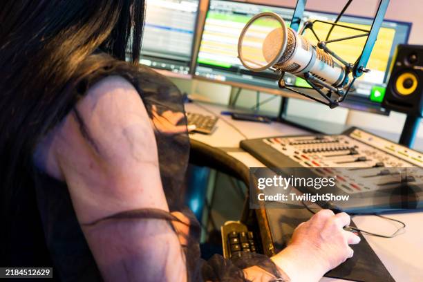 woman live on air in studio recording music room - radio dj stock pictures, royalty-free photos & images