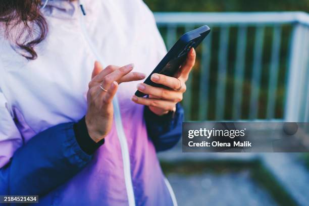 woman using smartphone after workout - de media stockfoto's en -beelden