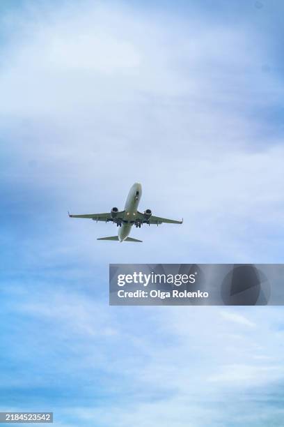 airplane cutting through clouds in troposphere against blue sky - troposphere stock pictures, royalty-free photos & images