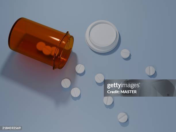 a bottle of pills is open and scattered on a table - scattered stock pictures, royalty-free photos & images