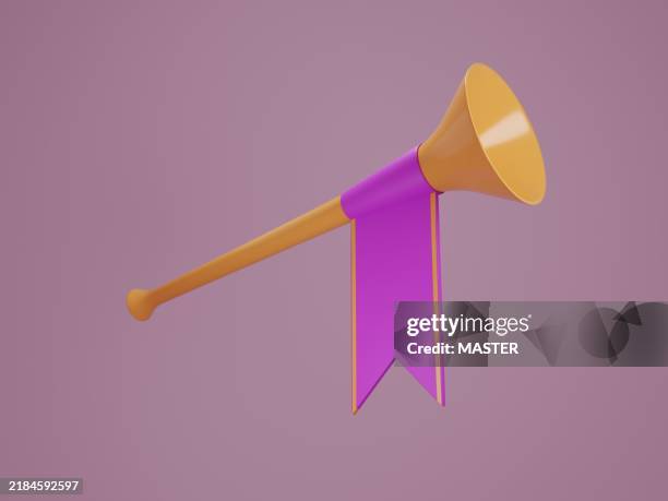 a large orange trumpet with a purple ribbon tied to it - blaasinstrument stockfoto's en -beelden