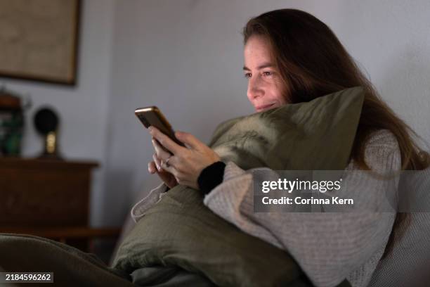 woman using her phone at home - stock photo - tinder stock pictures, royalty-free photos & images