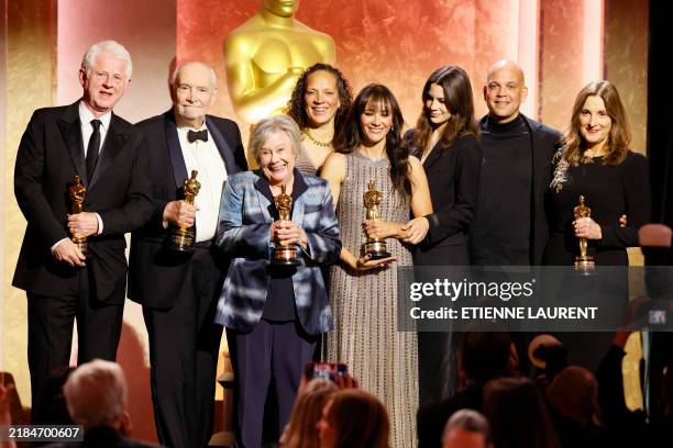 British screenwriter and director Richard Curtis poses with the Jean Hersholt Humanitarian Award, British-US film producer Michael G. Wilson poses...