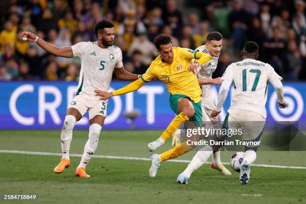 Nishan Velupillay of the Socceroos is challenged by Ali Al Bulayhi, Abdullah Al Hamddan and Hassan Al Tambakti of Saudi Arabia during the Round 3...