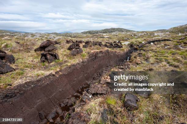 cutting peat for fuel-isle of harris, scotland. - outer hebrides stock pictures, royalty-free photos & images