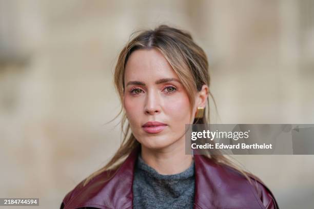 Virginie Conte wears gold Bruna the Label earrings, a grey cos top, during a street style fashion photo session, on November 11, 2024 in Paris,...