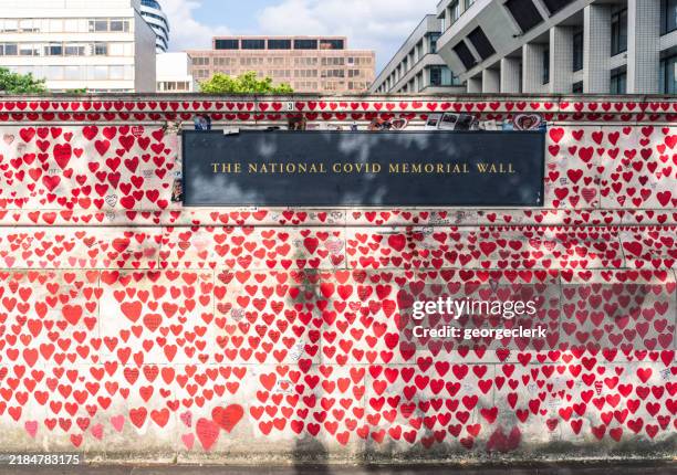 national covid memorial wall with hospital in background - memorial stock pictures, royalty-free photos & images