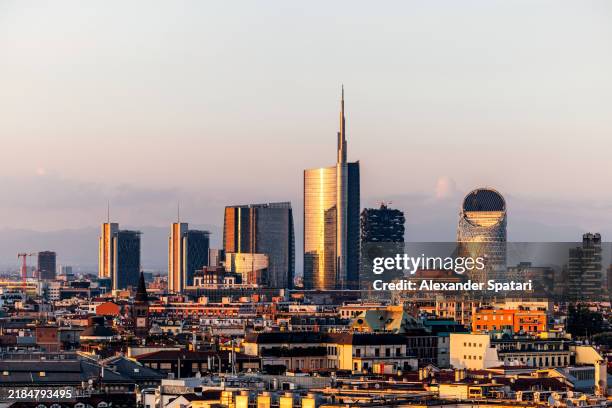 modern skyscrapers in porta nuova business district at sunset, milan, italy - milan stock pictures, royalty-free photos & images
