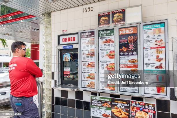 Miami, Florida, Biscayne Boulevard, Checkers fast food restaurant, man reading menu, walk-up window.